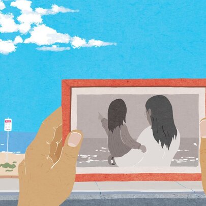 A graphic representation of two hands holding a picture frame in front of a beach with blue sky, a black and white picture of a mother and her child in the frame.