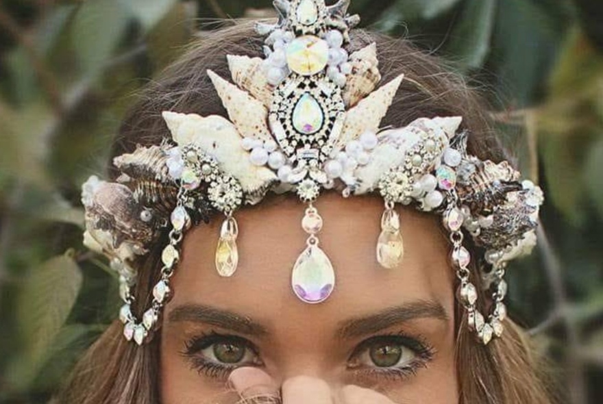 Woman wearing a glittering headdress of pearls and crystals.