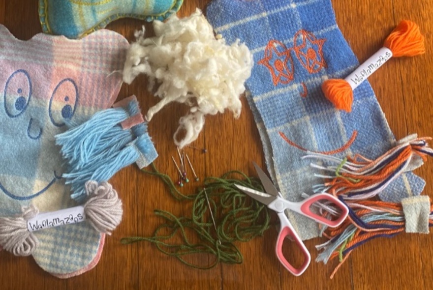 Wool scraps made into toys with faces and wool.