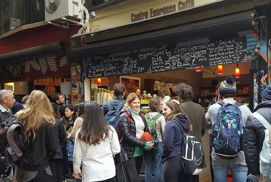 A crowd standing outside Centre Espresso Coffee.