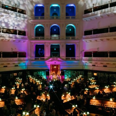 The interior of State Library Victoria's iconic Domed Reading Room during a nighttime event. 