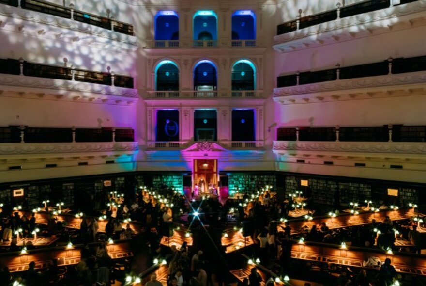The interior of State Library Victoria's iconic Domed Reading Room during a nighttime event. 