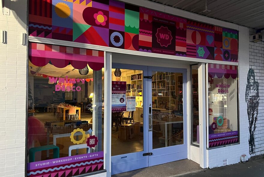 The colourful pink-toned shopfront of Whimsy Disco.