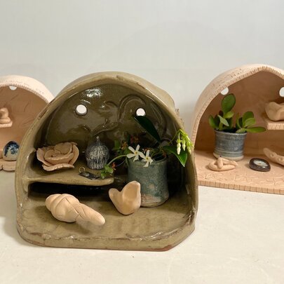 Wooden miniature shrines containing special objects.