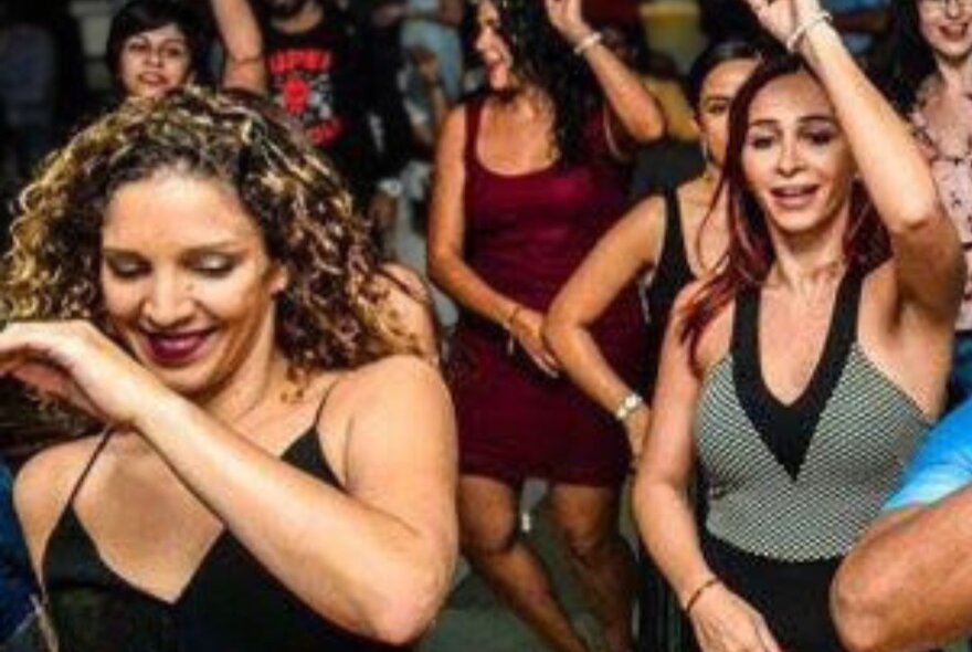 Women dancing to Cuban music.