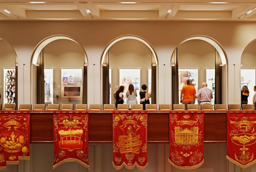 Red and gold banners hanging from indoor balcony.