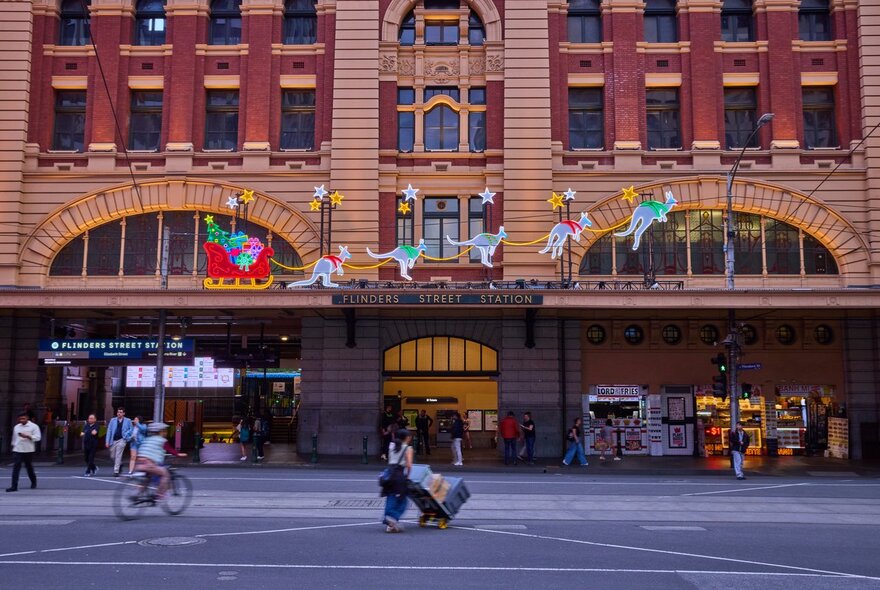 Light up display of five kangaroos pulling Santa's sleigh. 
