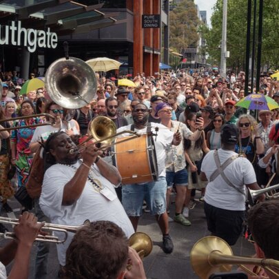 New Orleans-style jazz band parading past crowds gathered at Southgate.