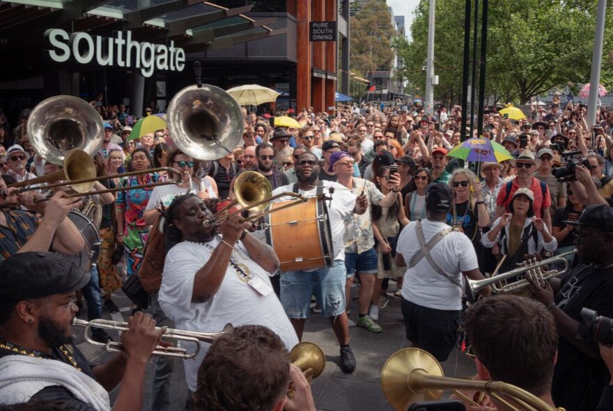 New Orleans-style jazz band parading past crowds gathered at Southgate.