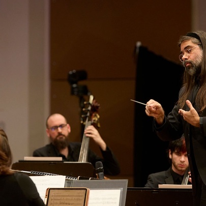 A conductor and some musicians of the Melbourne Symphony Orchestra rehearsing.