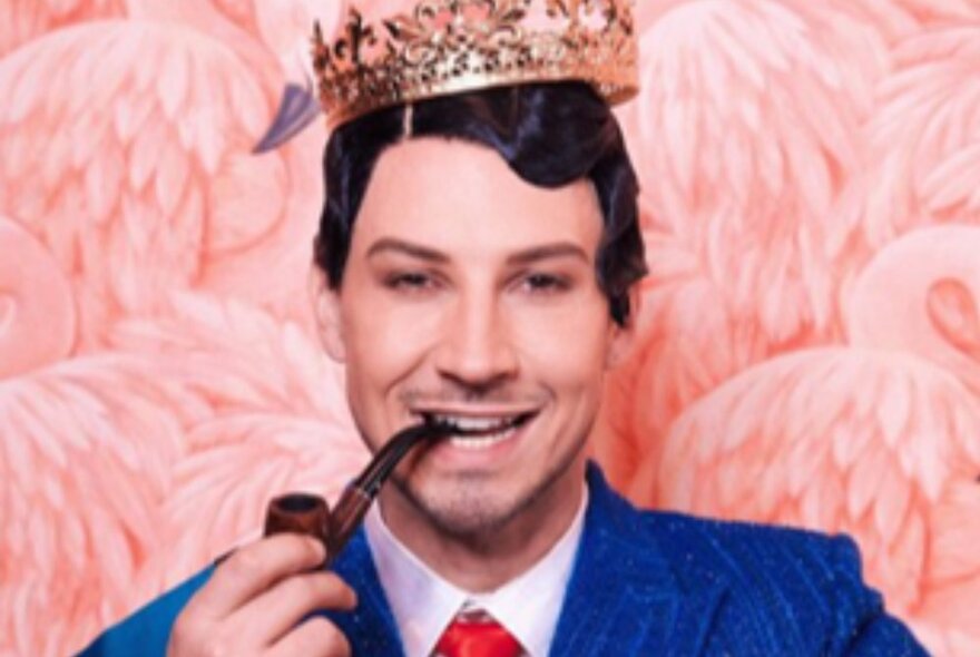 A man wearing a suit, a crown superimposed on top of his head, pretending to smoke a pipe.