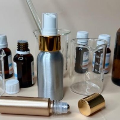 A collection of essential oils, spray bottles and a perfume roller ball.