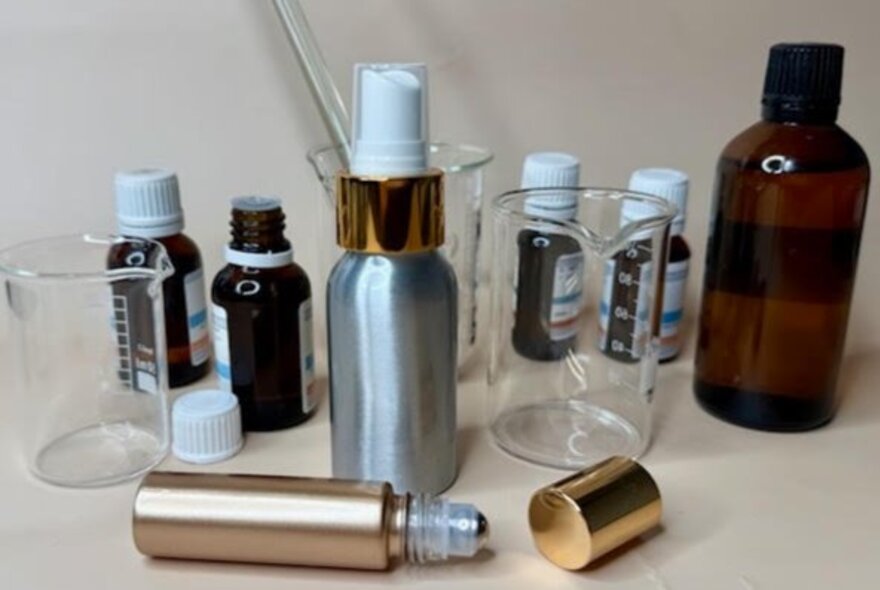 A collection of essential oils, spray bottles and a perfume roller ball.