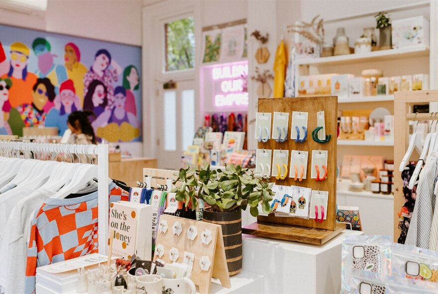 Goods on display including clothing, jewellery, and ceramics, inside the Queen Victoria Women's Centre SHOP!