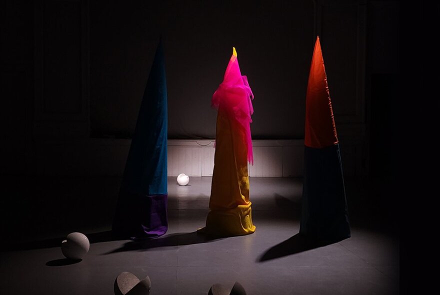 Sculptural works in a gallery space that look like giant coloured candles.