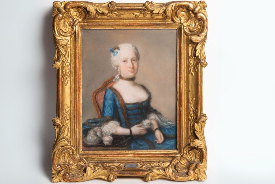 An oil portrait painting of a woman in Regency costume, in an elaborate gold frame.