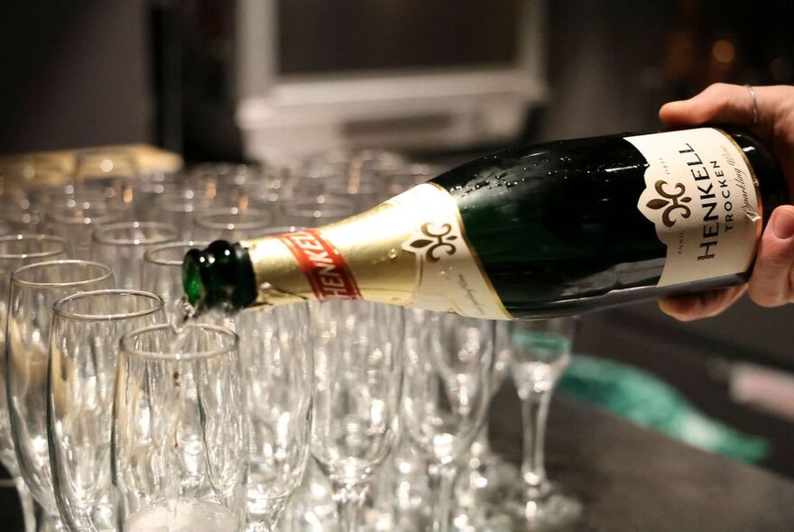 German white wine being poured into glasses.