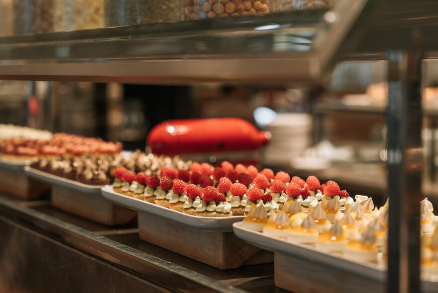 Dessert buffet station including strawberry-topped pastries.