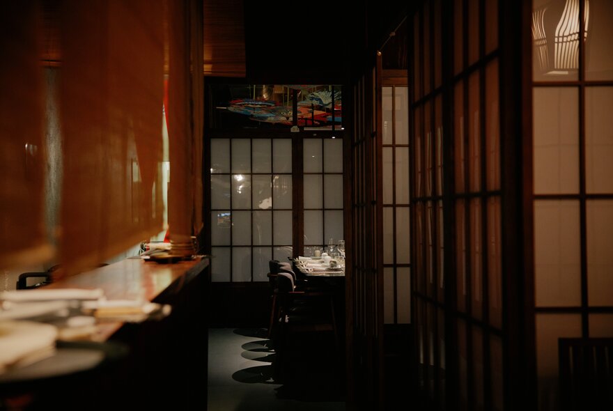 A dimly lit Japanese restaurant with traditional sliding doors.
