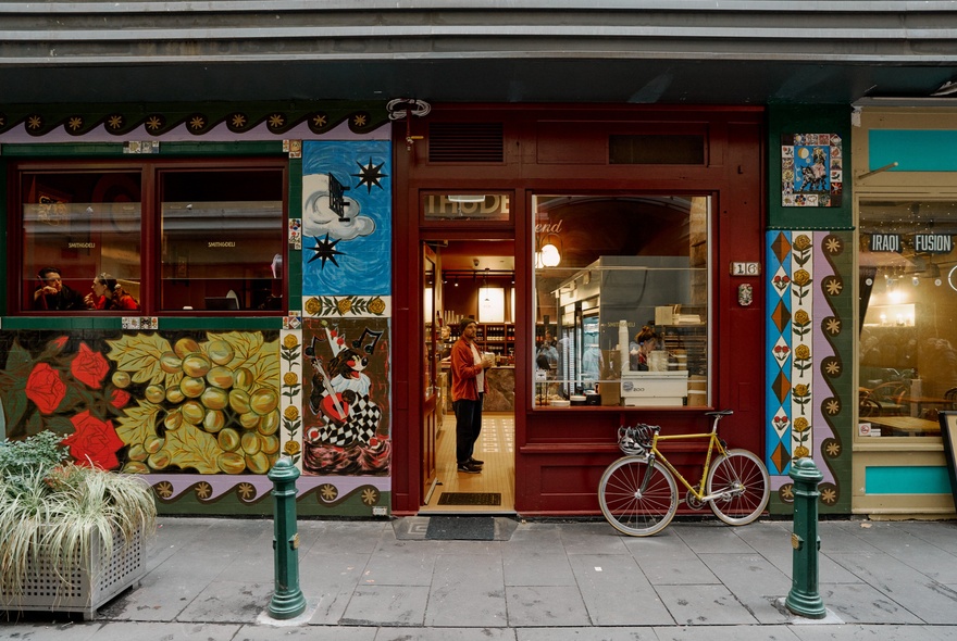 Colourfully painted store exterior with murals and bicycle.