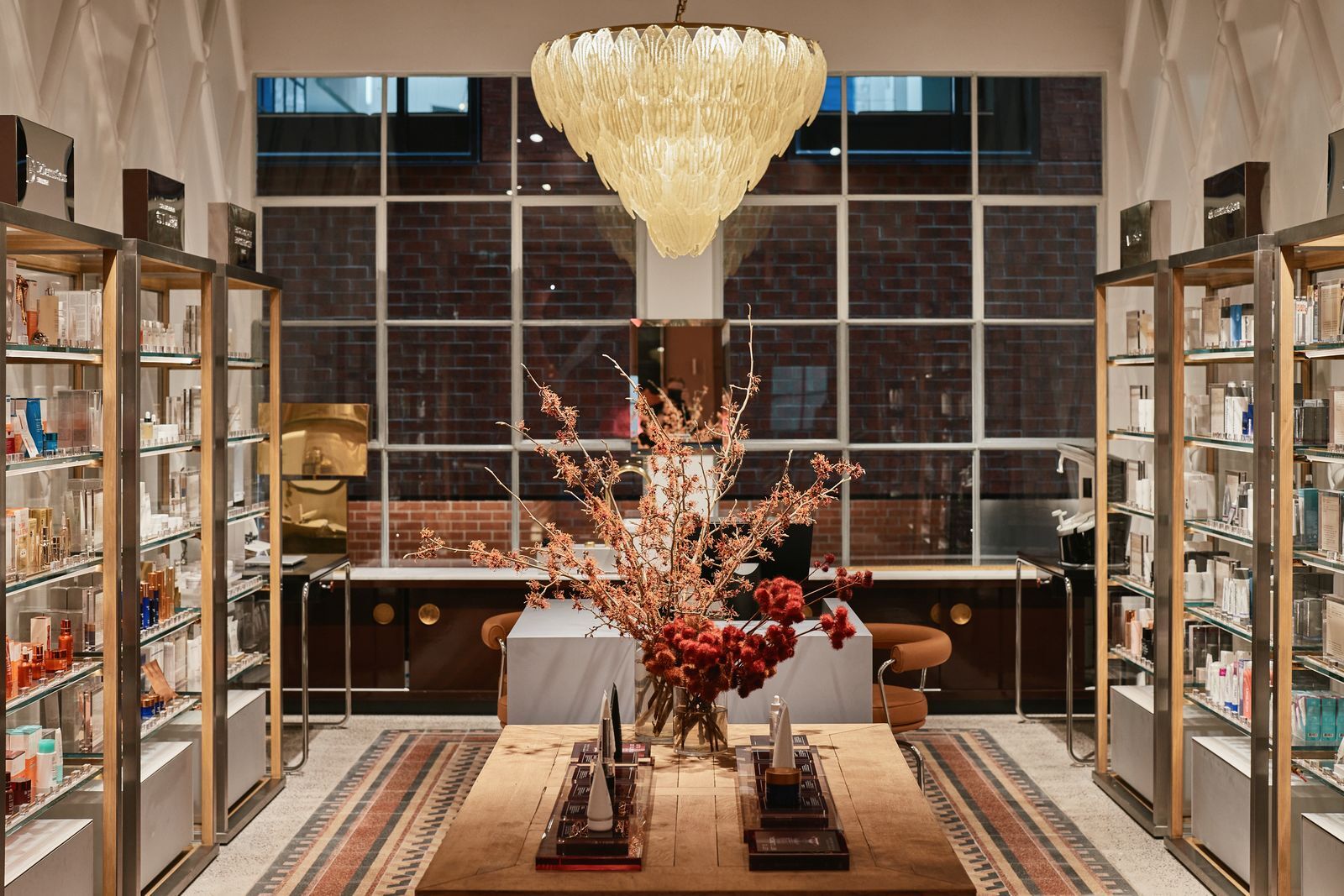 A beauty store with a chandelier and flowers.