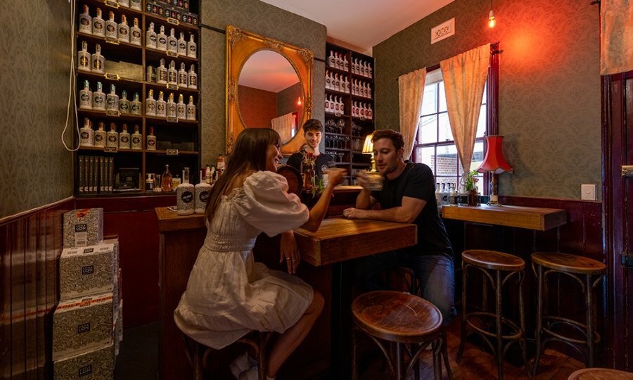 A couple drinking in a dimly lit bar.