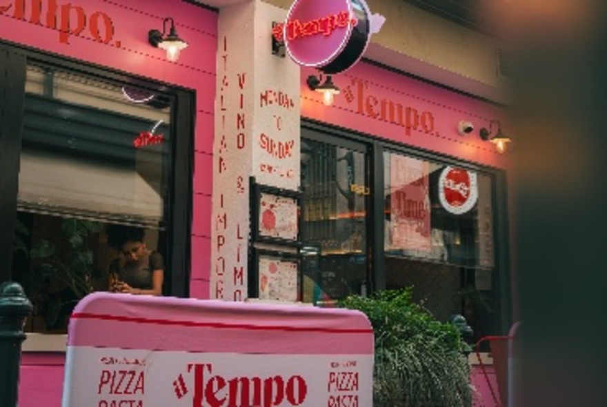 Restaurant exterior with pink signage.