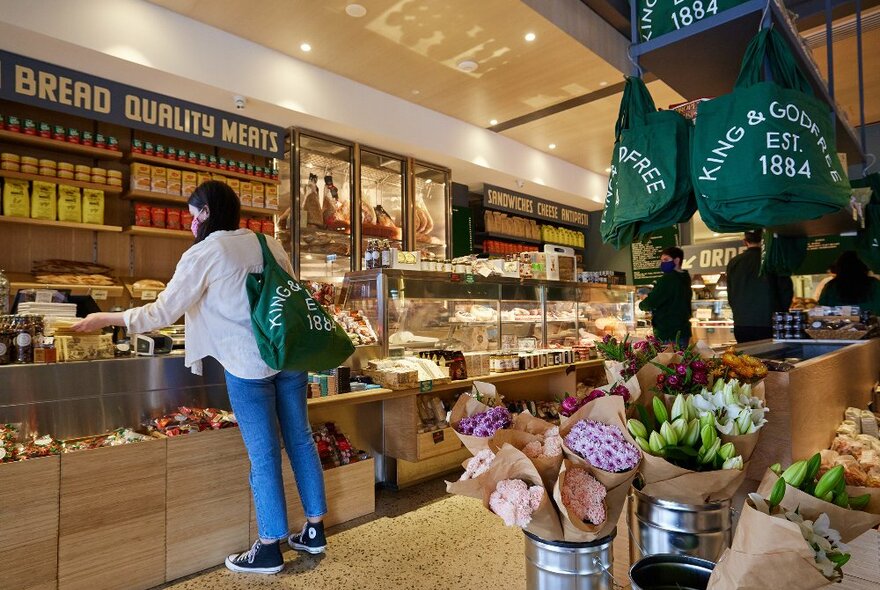 A woman is shopping in a local deli