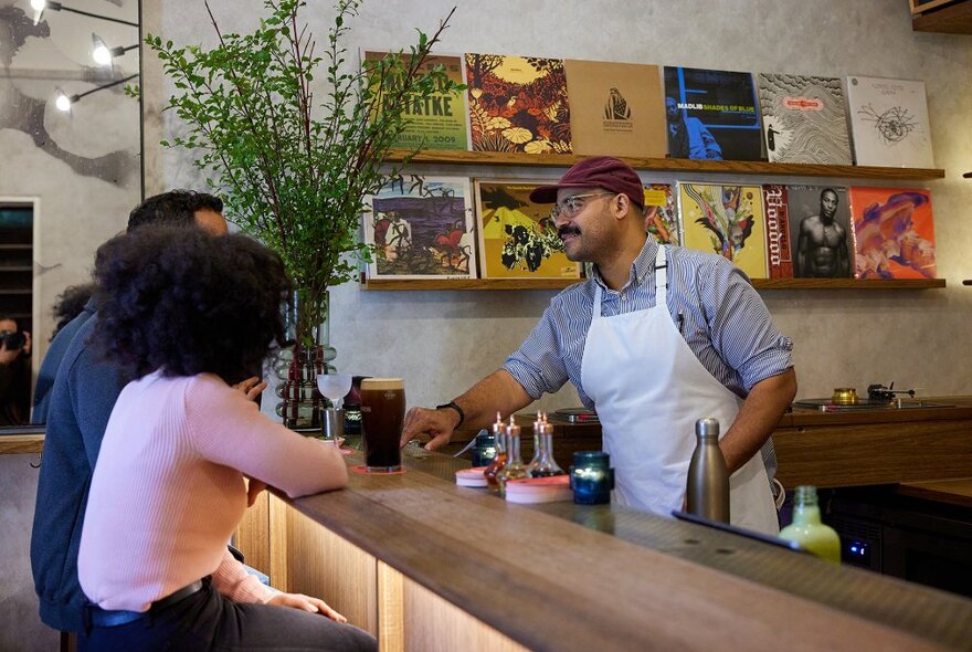 A couple ordering Guinness at a stylish bar.