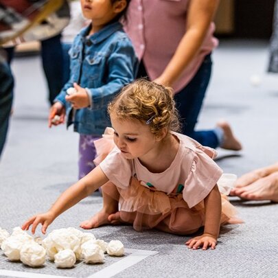 Young children and adults taking part in a multi-sensory interactive dance and play session at ArtPlay.