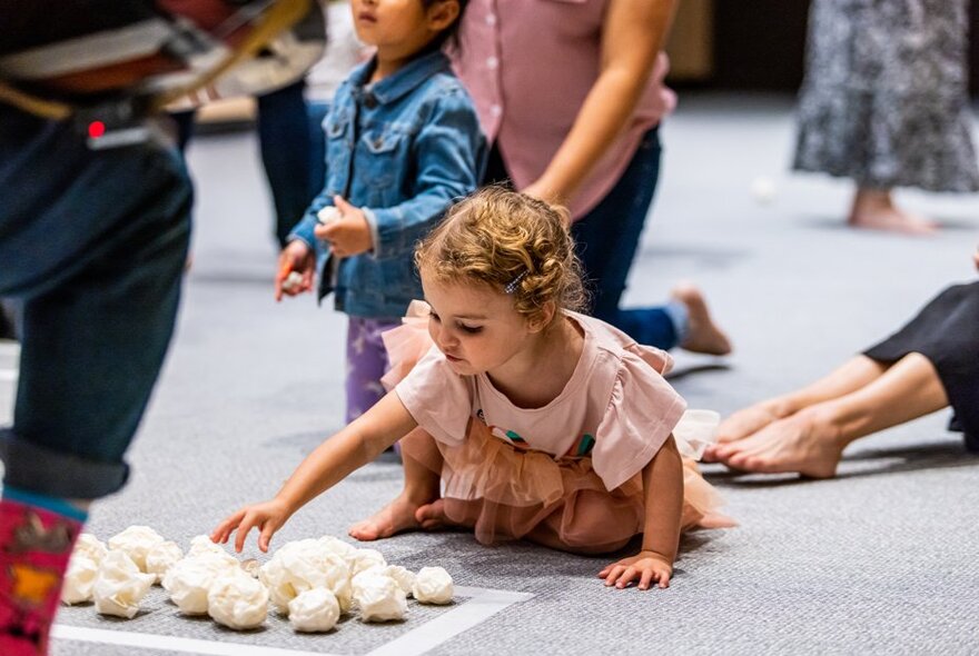 Young children and adults taking part in a multi-sensory interactive dance and play session at ArtPlay.
