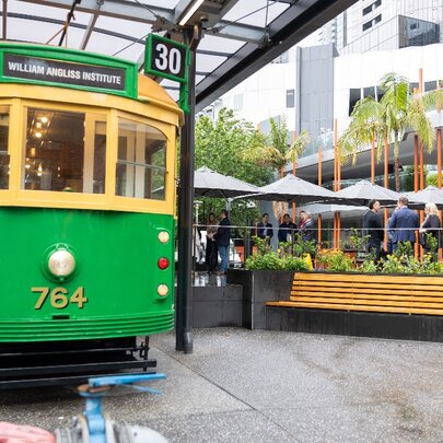 The heritage Melbourne Tram cafe, parked in an outdoor garden cafe setting with seating and umbrellas.
