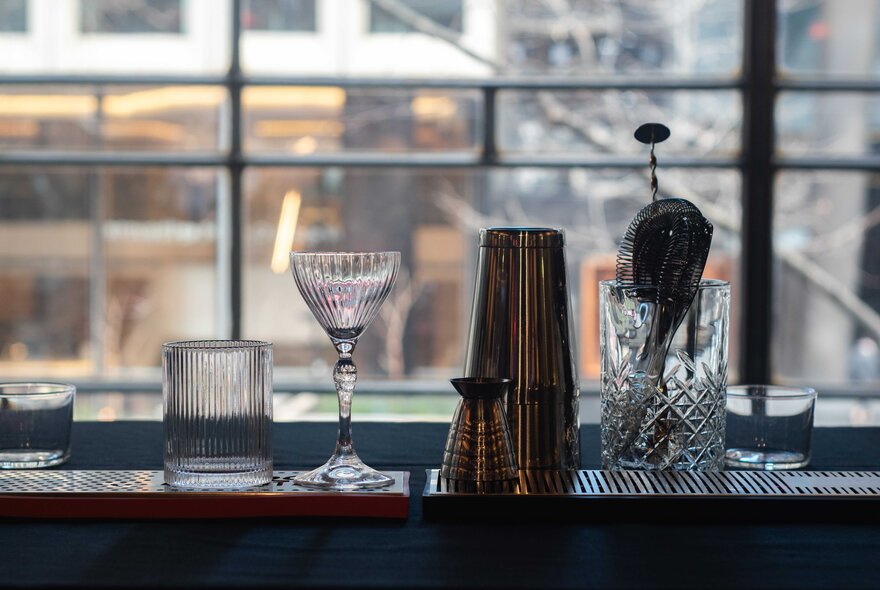 Cocktail making equipment featuring a shaker and glasses