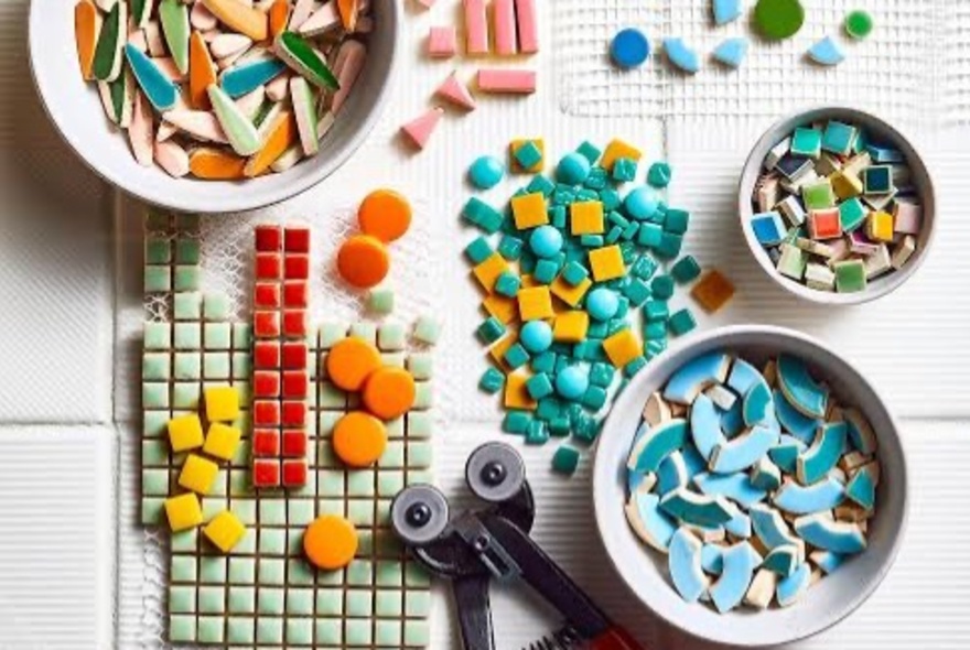 Bowls of mosaic tiles with equipment.