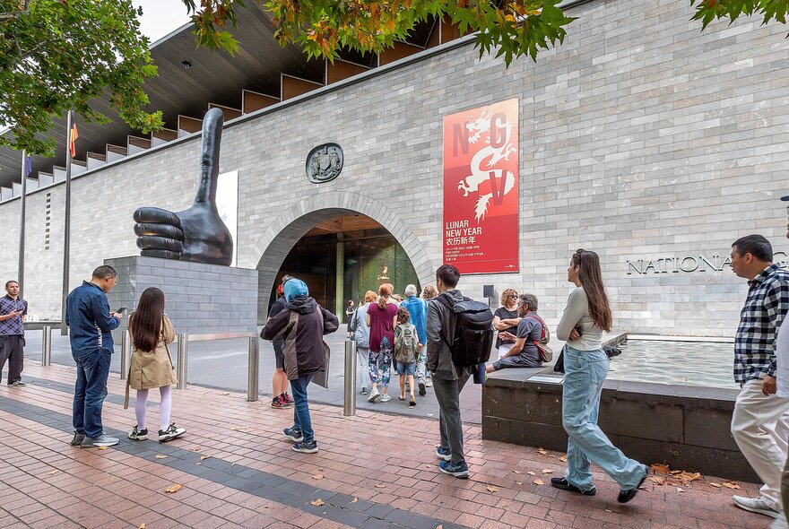 The exterior of NGV Melbourne with people walking past. 