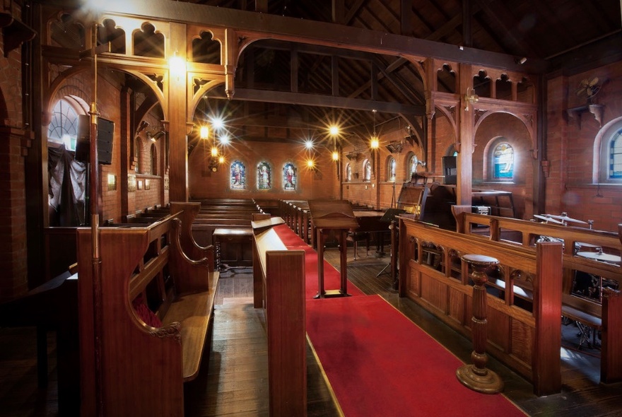 Missions to Seafarers chapel with arts and crafts woodwork screen and stalls, central red carpet.