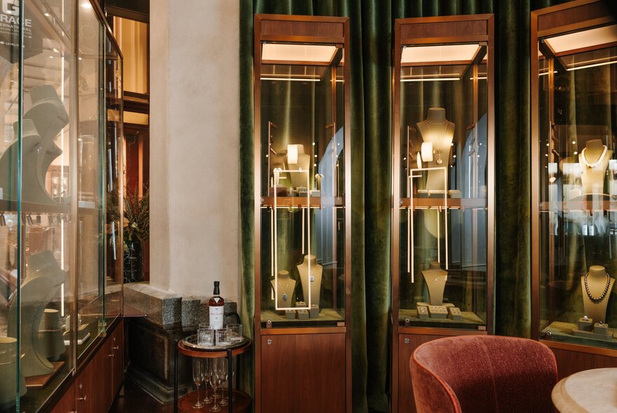 The opulent interior of a jewellery store with glass and timber display cases.