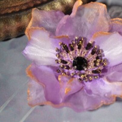 Floral accessorie made from silk and beads.