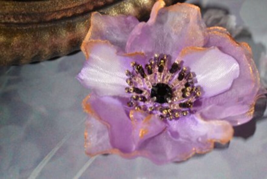 Floral accessorie made from silk and beads.