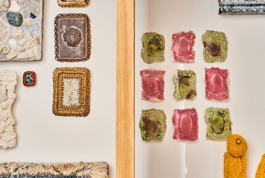 An assortment of small framed artworks on display on the white walls of the gallery space at Craft.
