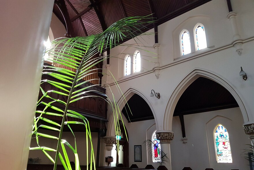 Interior of the German Lutheran Trinity Church showing stained glass windows and timber ceiling.