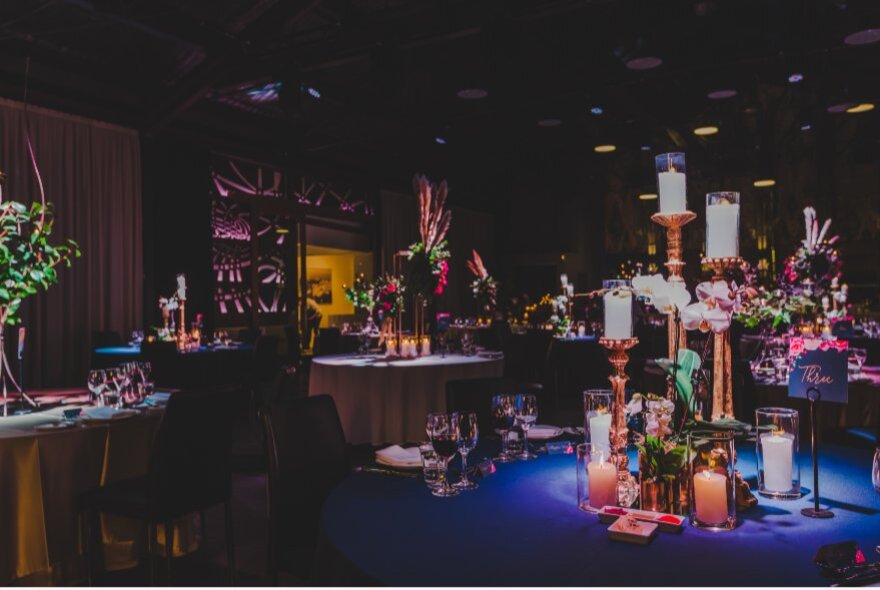 Dimly lit space with candle displays.