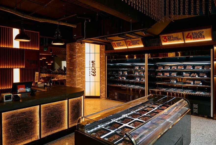 Cuts of meat on display in a brick-lined, moodily lit restaurant.