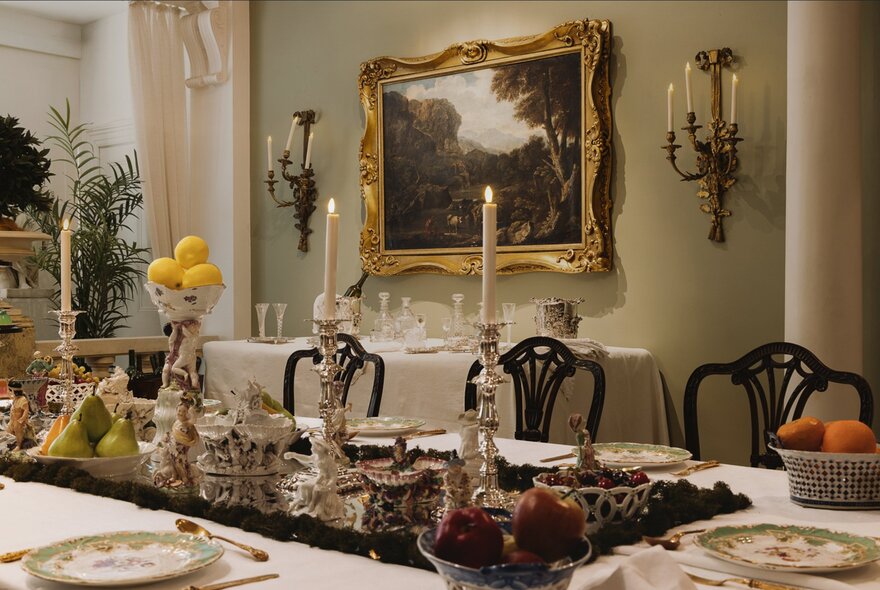Georgian antiques decorating a dining table with seating in a heritage home setting.