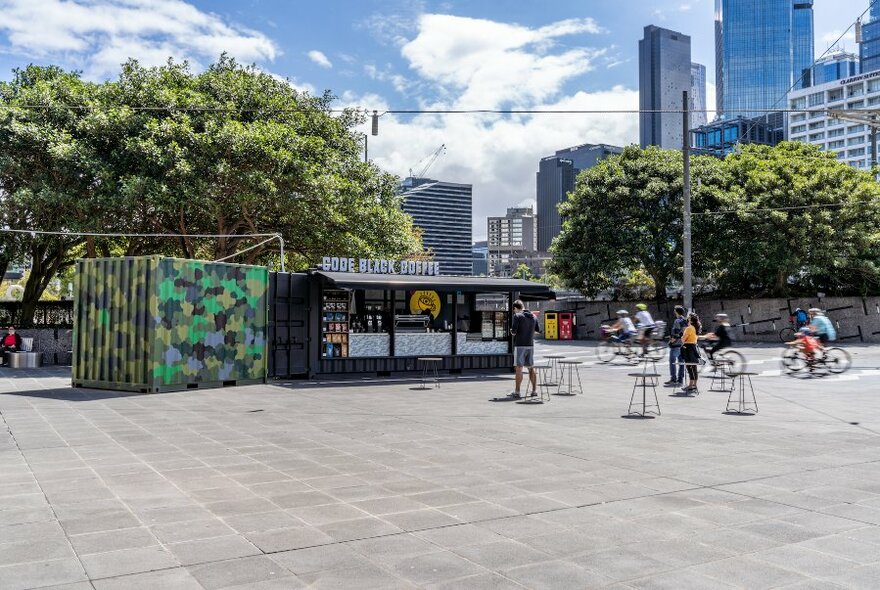 Code Black Coffee pop-up on Southbank. Cyclists and pedestrians in background.