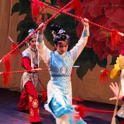 Traditional Taiwanese dancers with red twirling sticks.