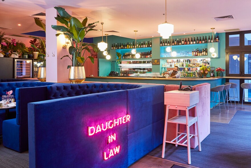 Neon sign, bar and booths inside Daughter in Law Indian restaurant.