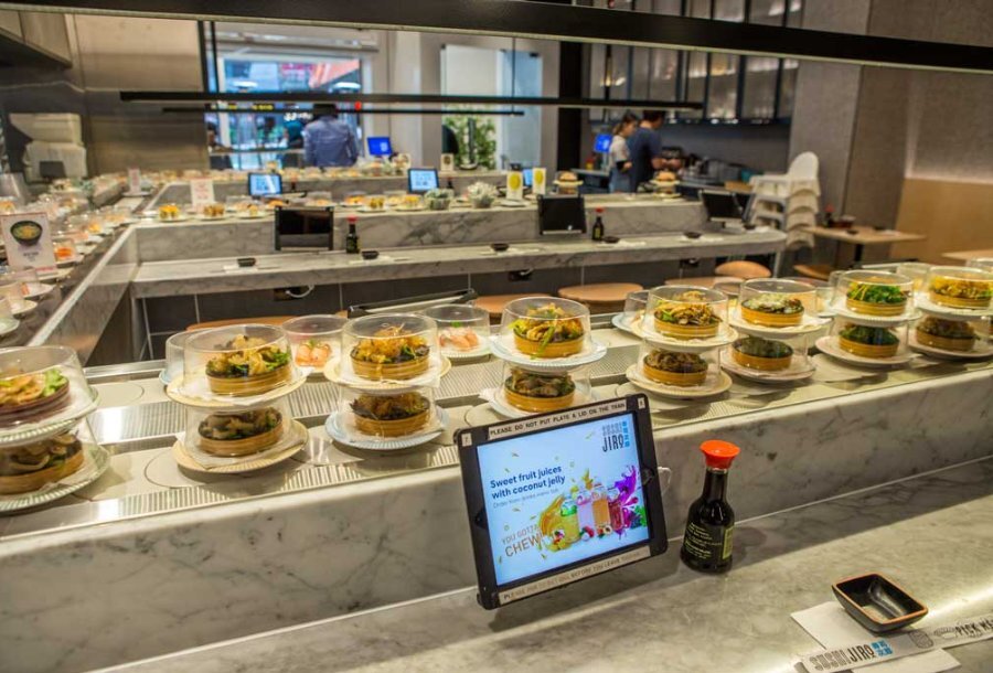 A sushi train conveyor belt in a Japanese restaurant.