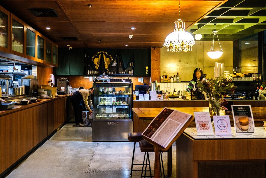 Inside a dimly-lit Japanese-style cafe. 