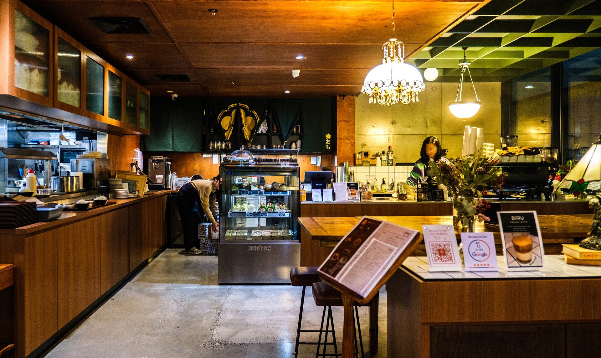 Inside a dimly-lit Japanese-style cafe. 